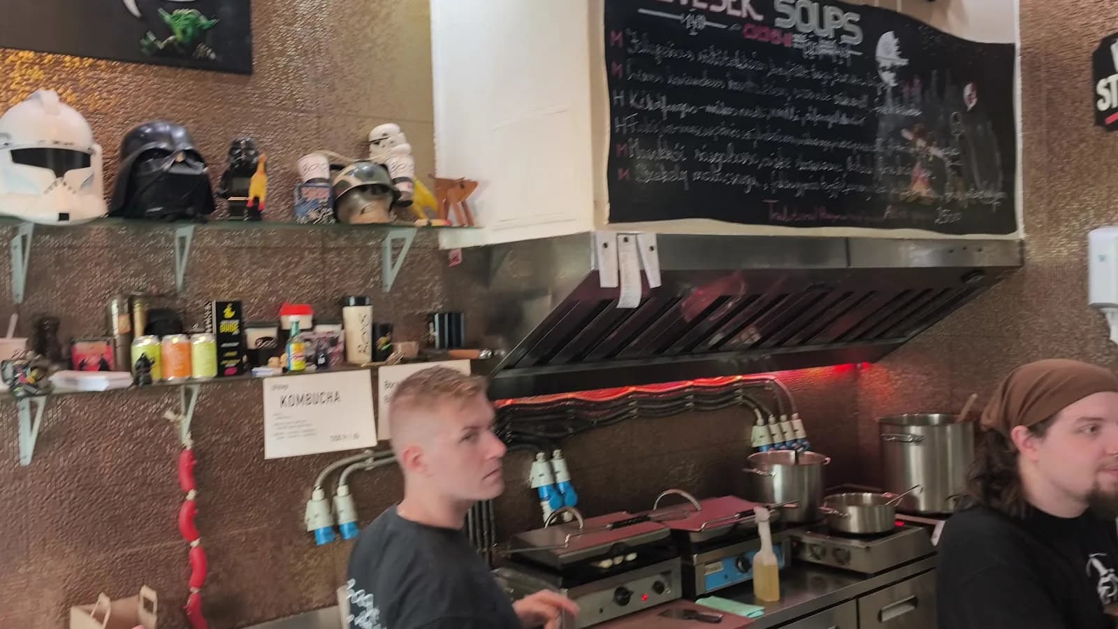 The Bors kitchen beneath the daily chalkboard and playful sci-fi helmets