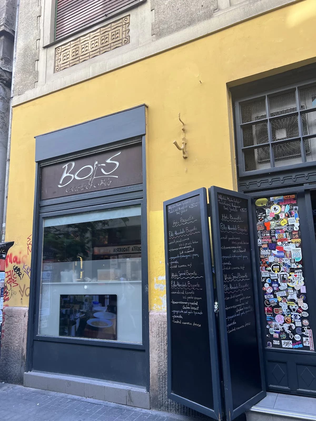 The tall yellow Bors Gastro Bar frontage with chalkboards at the entrance