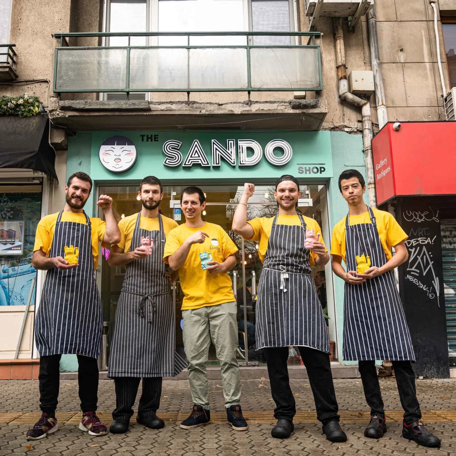 The Sando Shop team outside the storefront