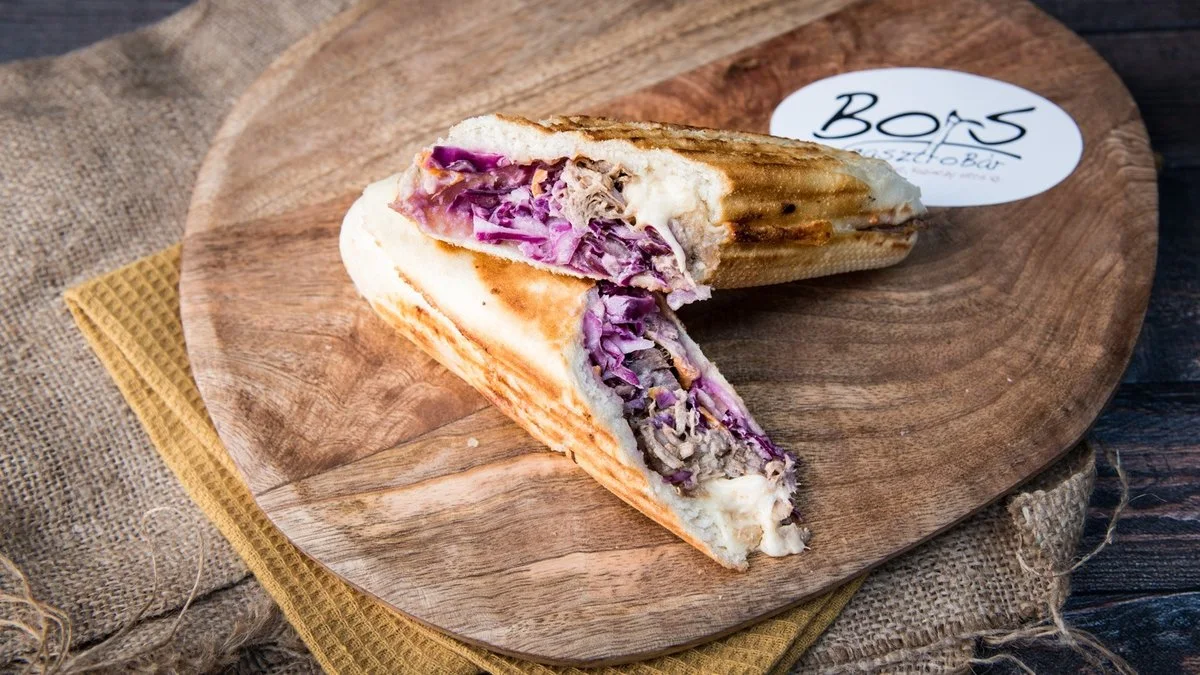 French Lady toasted baguette cut open to show chicken, raspberry-onion jam and cheese