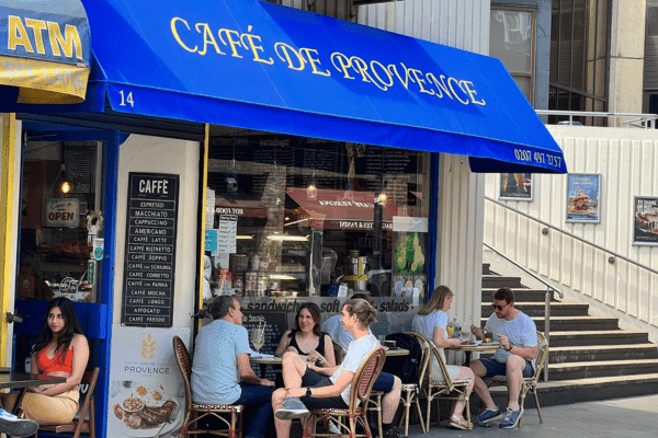 The cobalt-blue Café de Provence awning on Drury Lane
