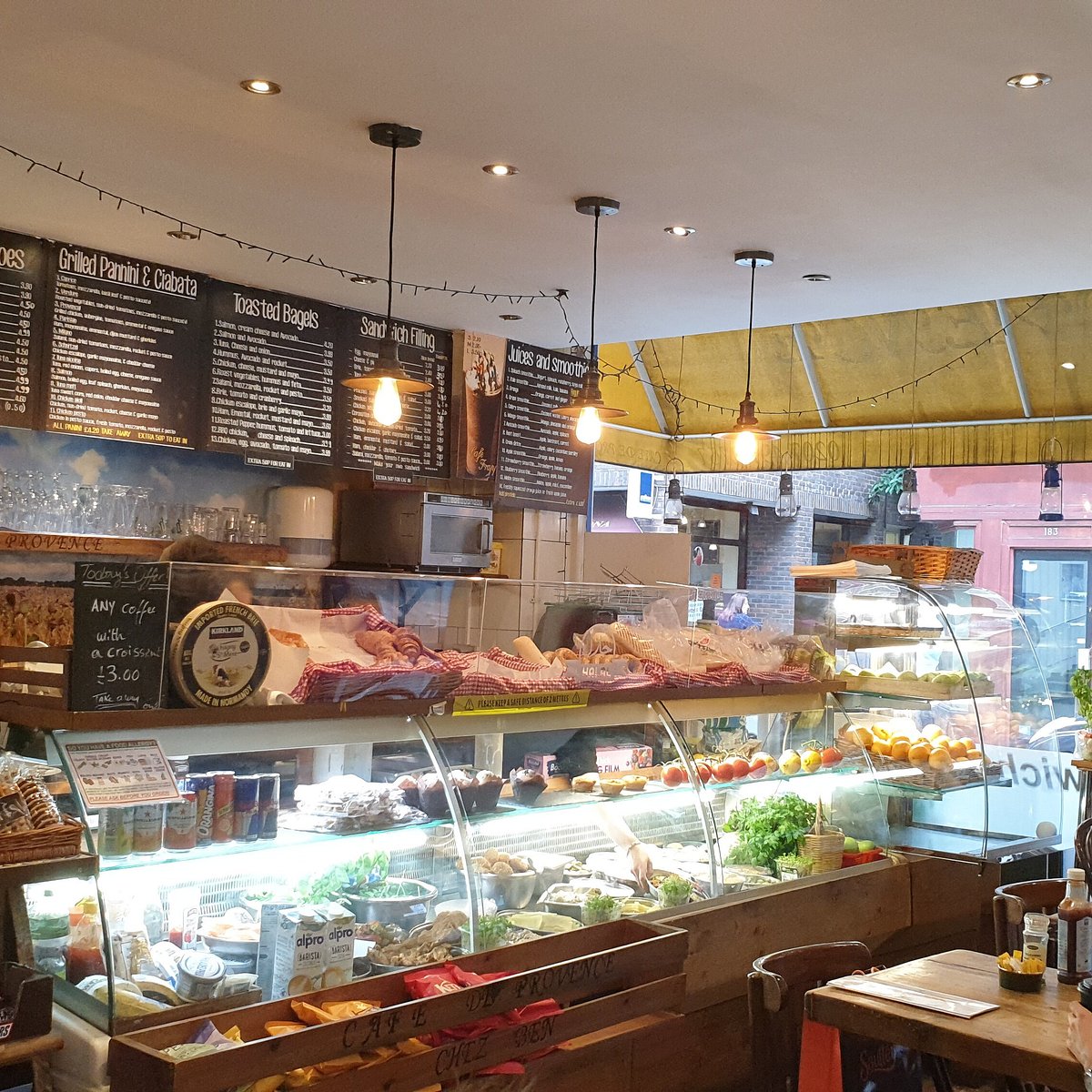 Café de Provence counter with chalkboard menu and fresh food display