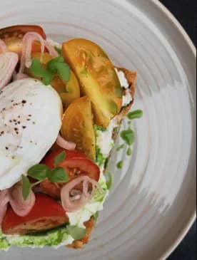 Tomato, avocado and poached egg toast from Cafe Strange Brew's Instagram