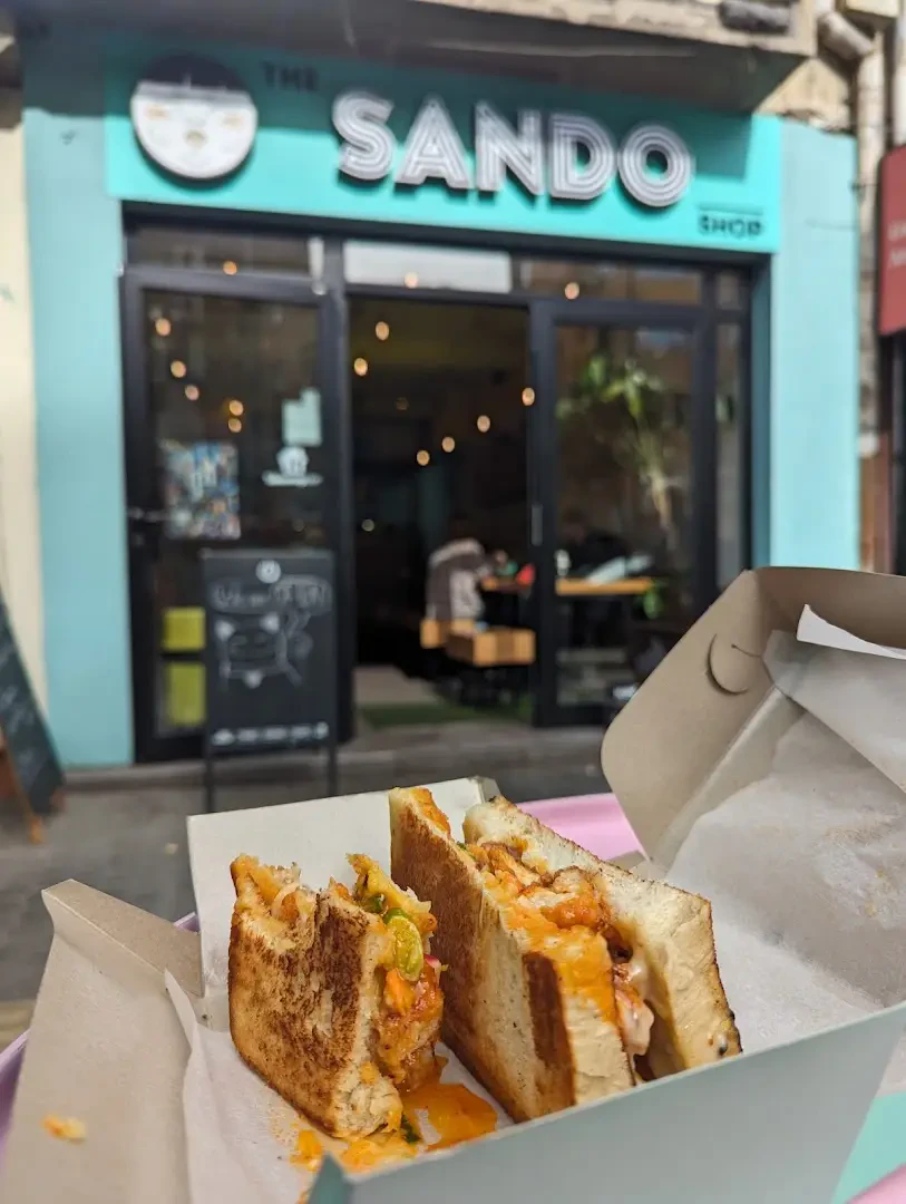 A Sando Shop sandwich held outside the Sofia storefront